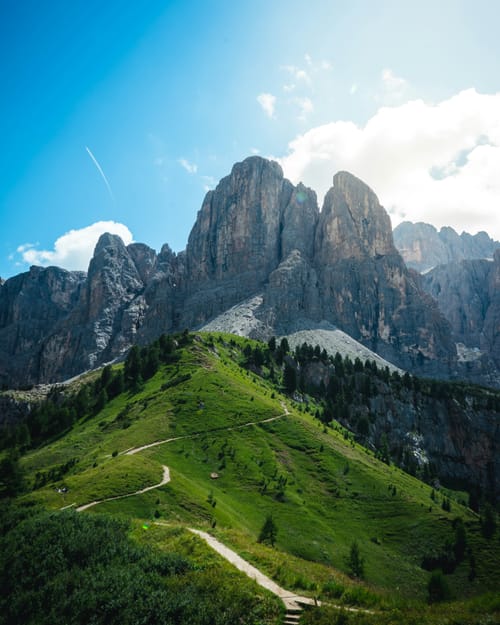 A path through fields leading to a mountains.