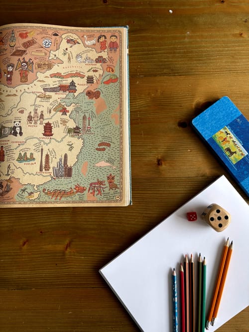 A book about maps, paper and some pencils and dice